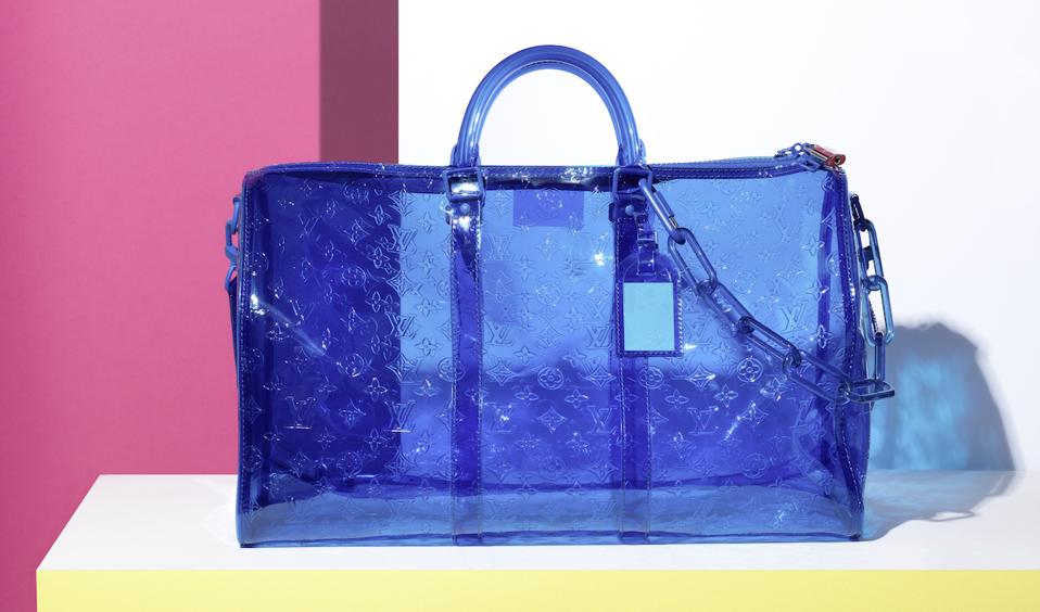 blue PVC handbag on white shelf