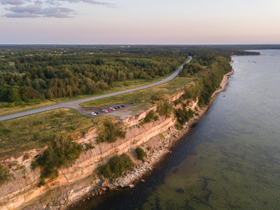 Drive-in sunset: people gather to watch sunset at Türisalu cliff near Tallinn, Estonia.