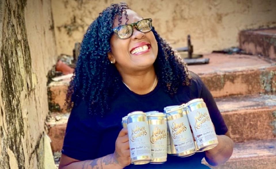 New Beer Kulture CEO and President Latiesha Cook holds an example of a Kulture Kollab beer brewed to raise money for charity.
