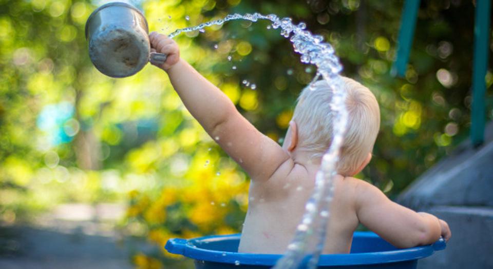 Child lifting water dipper.