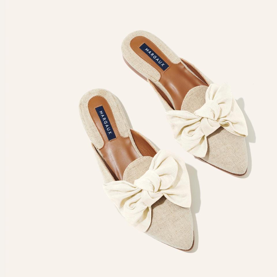 A silhouette inspired by traditional smoking slipper, but a backless, slip-on style gives it a laidback sensibility. The classic smoking slipper toe feels feminine thanks to an oversized bow.