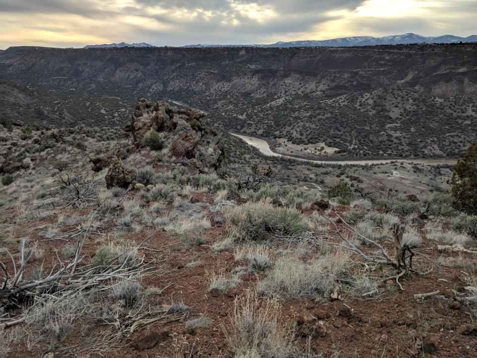 The Rio Grande winds below the Pajarito Plateau and the town of White Rock above.