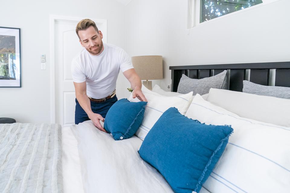 Orlando Soria fixing a pillow