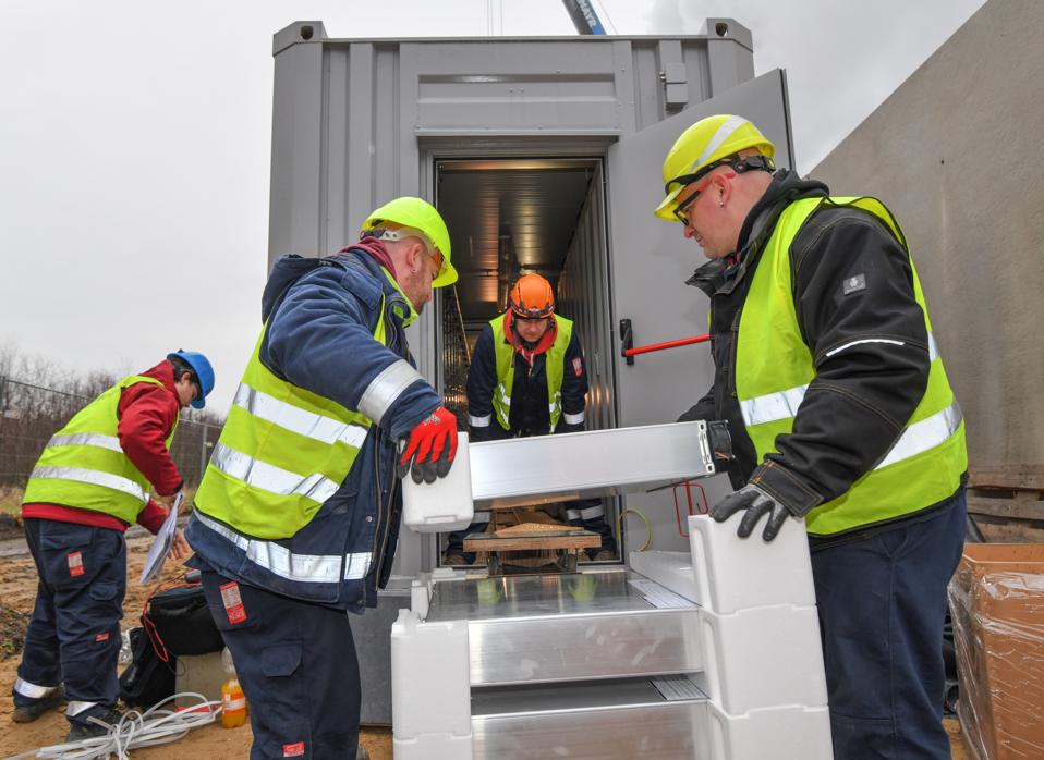 Workers putting together a lithium-ion battery facility in Lausitz, Germany.