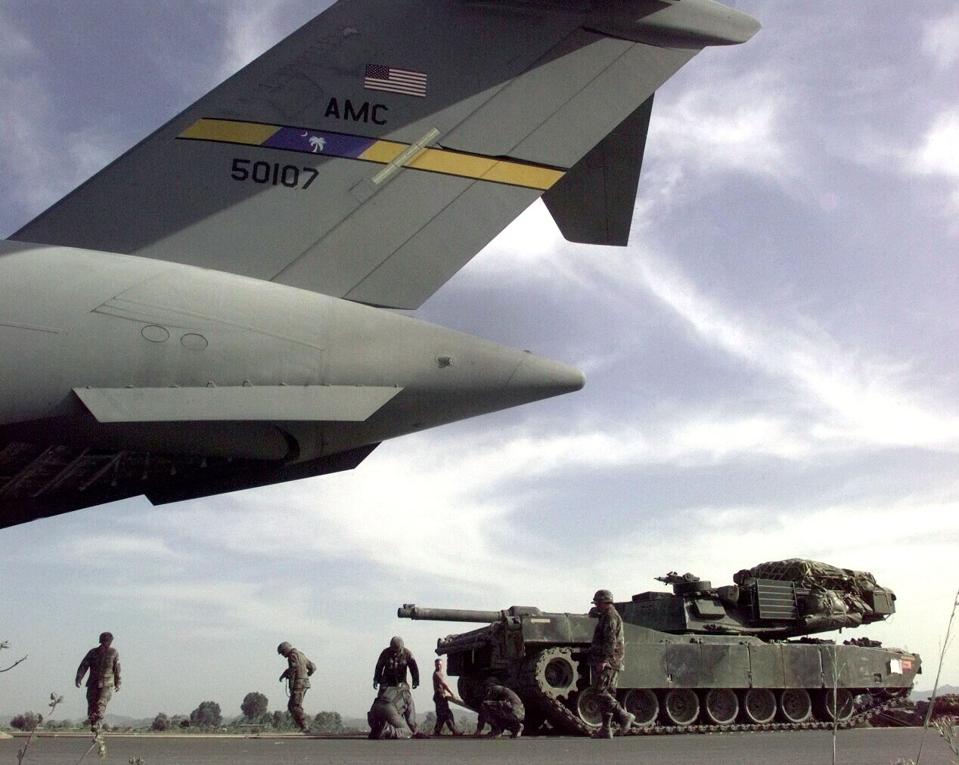Soldiers And Airmen Lay Down A Track Of Plywood As They Load A U S Army M 1A1 Abrams Tank Into A U