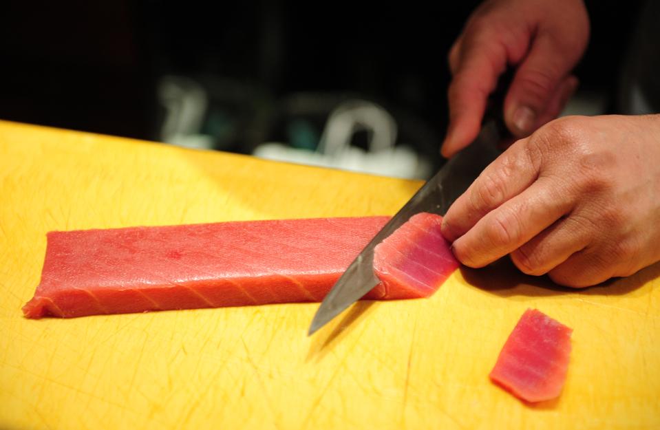 Sushi chef William Tawng prepares sushi