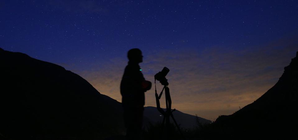 The photographer prepares to take pictures of the annual Perseid meteor shower in northern Italy. MARCO BERTORELLO / AFP via Getty Images