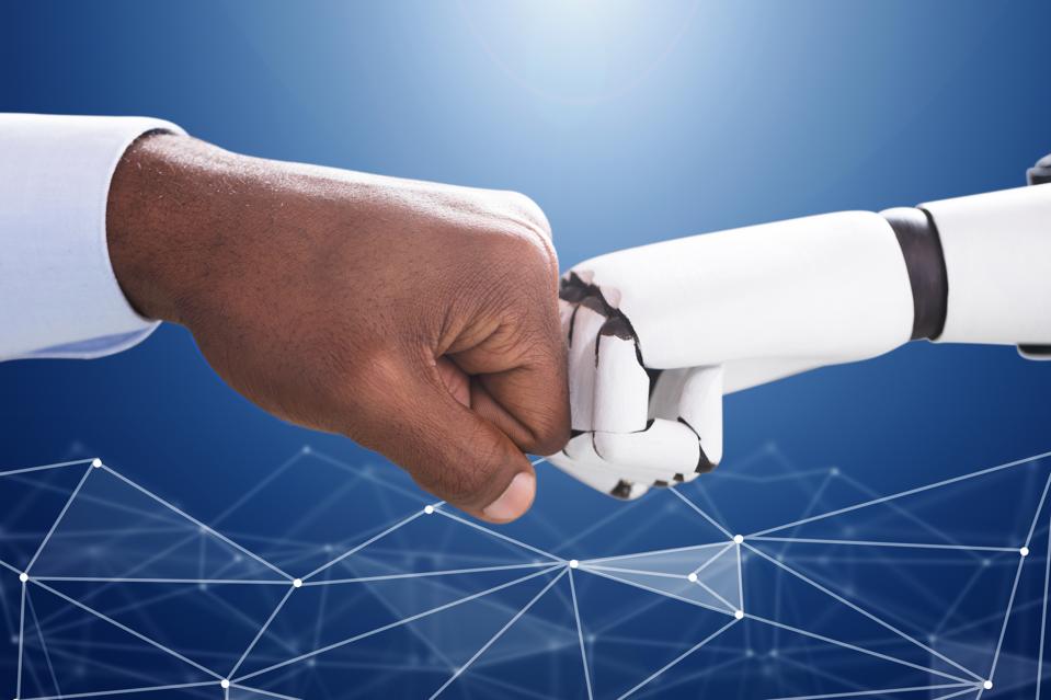 Human hand and a robot hand coming together for a fist bump.