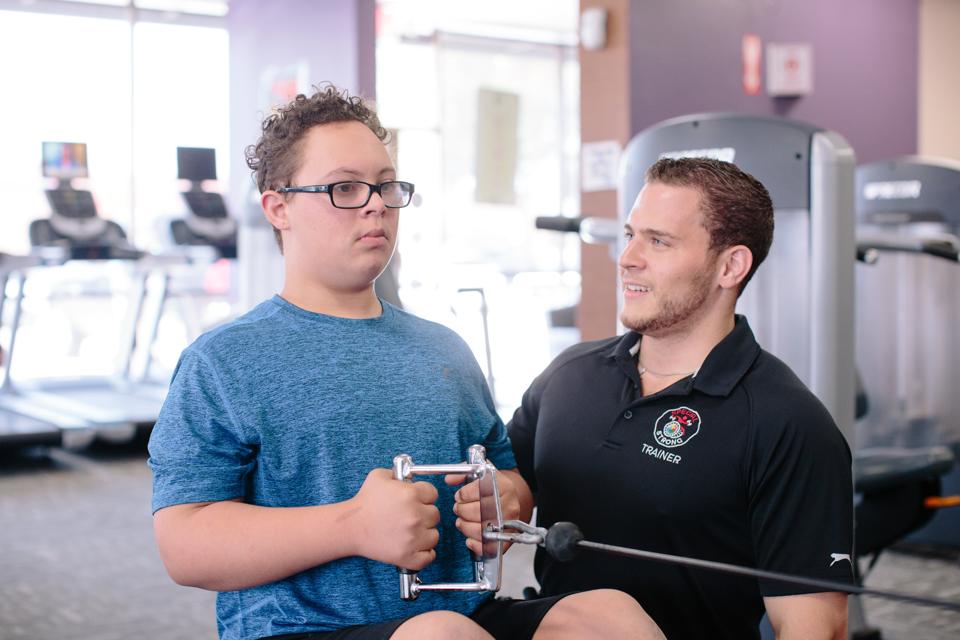 Daniel Steine works with a client at Special Strong in McKinney, Texas.