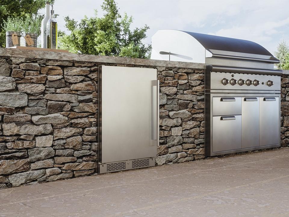 Outdoor kitchen with wine fridge.