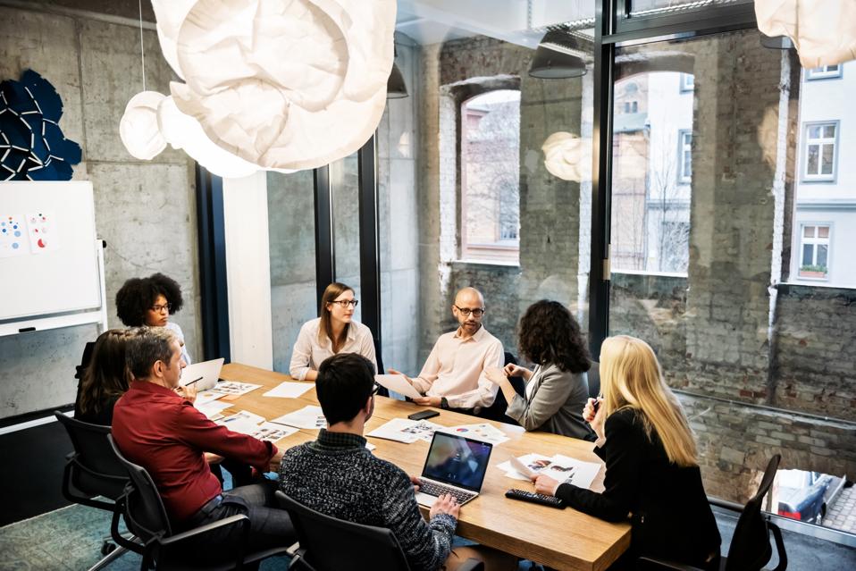 A group of young people in a business meeting.