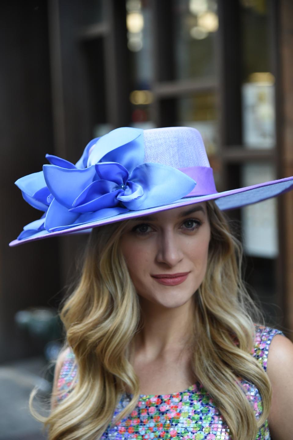 Hand blocked, silk taffeta bound, 3 layered sinamay broad brim boater accented with pointed petal flowers and embellished with beaded centers.