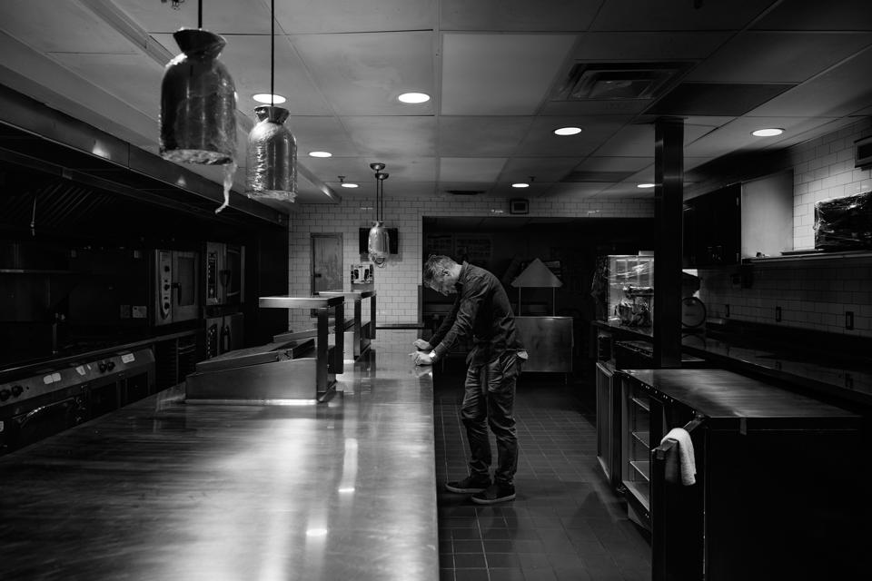 Bobby Stuckey stands in an empty restaurant kitchen