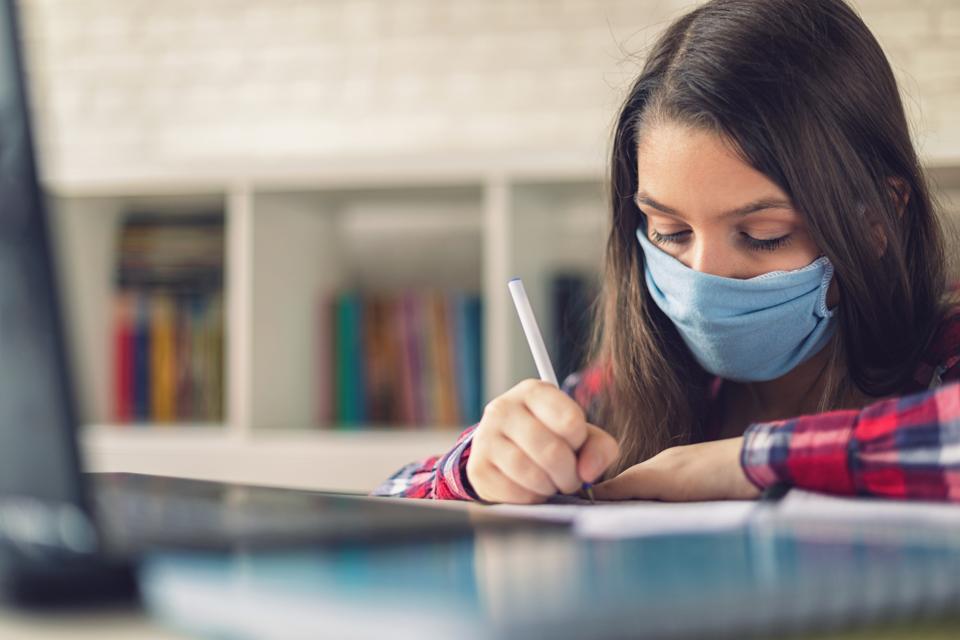 Teenage girl completing test at home during COVID-19 pandemic