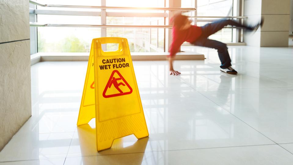 Man slips falling on wet floor