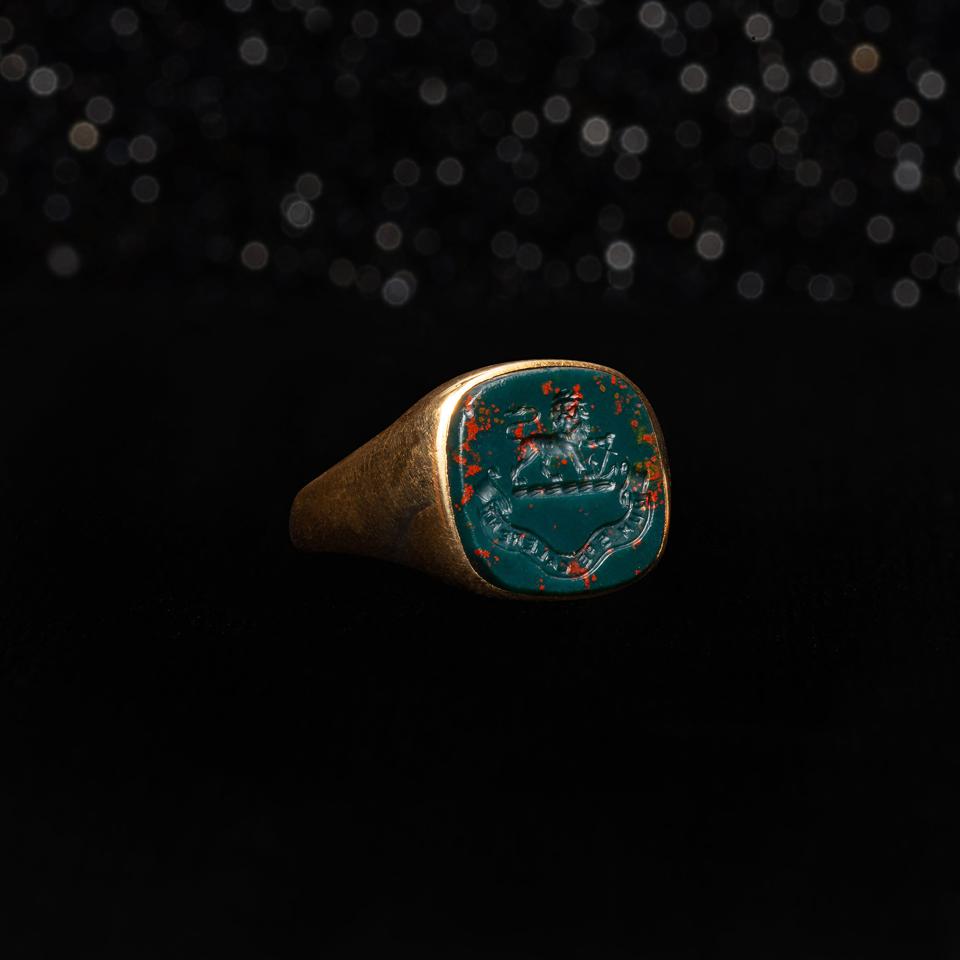 The Victorian Bloodstone Hope Intaglio Ring dates back to 1851 and is made of 18k Gold & Bloodstone Itaglio. Carved with a Lion and Anchor above a banner reading ″Dum Spe Calerant″ which roughly translates to ″While They Were Warm with Hope″.
