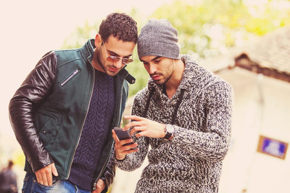 Two young men looking at a smartphone