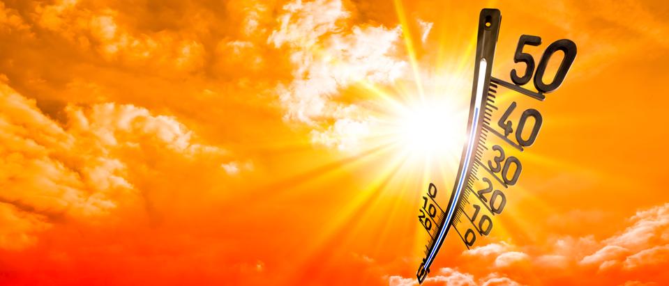 Summer background, bright sun on dramatic sky with thermometer