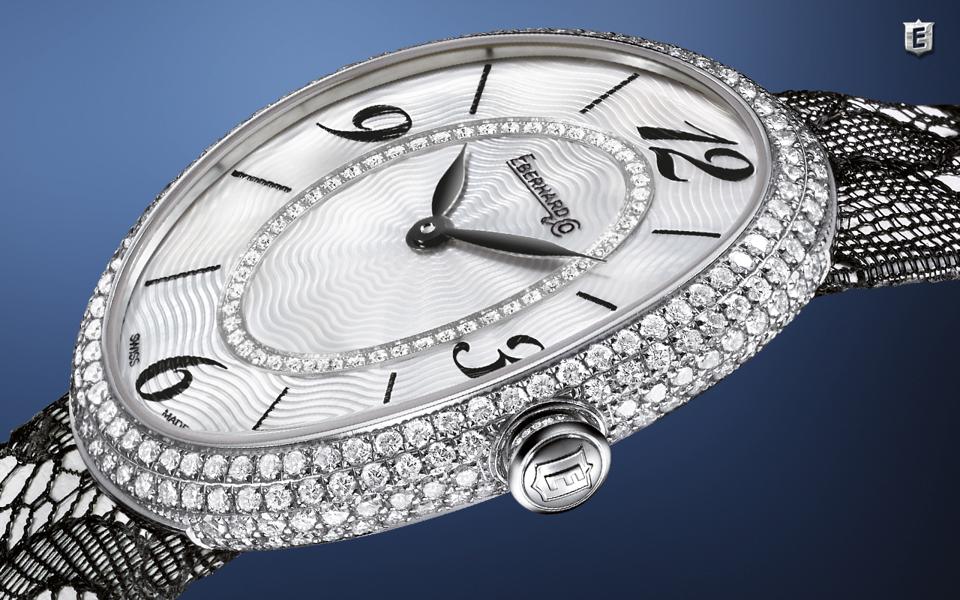 The Eberhard & Co Gilda is paved with diamonds, has a mother of pearl dial and black lace strap