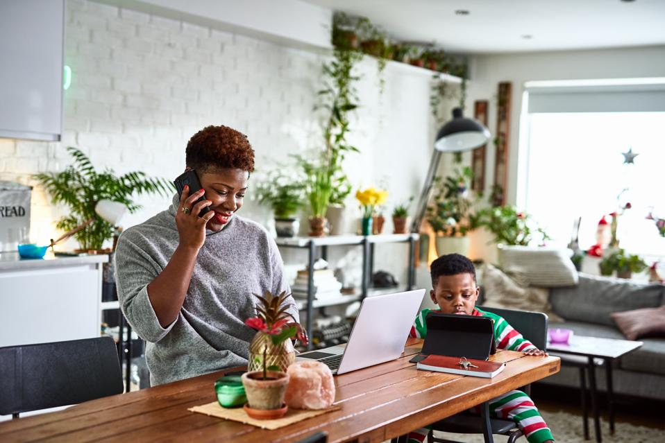 Mother working from home with son.