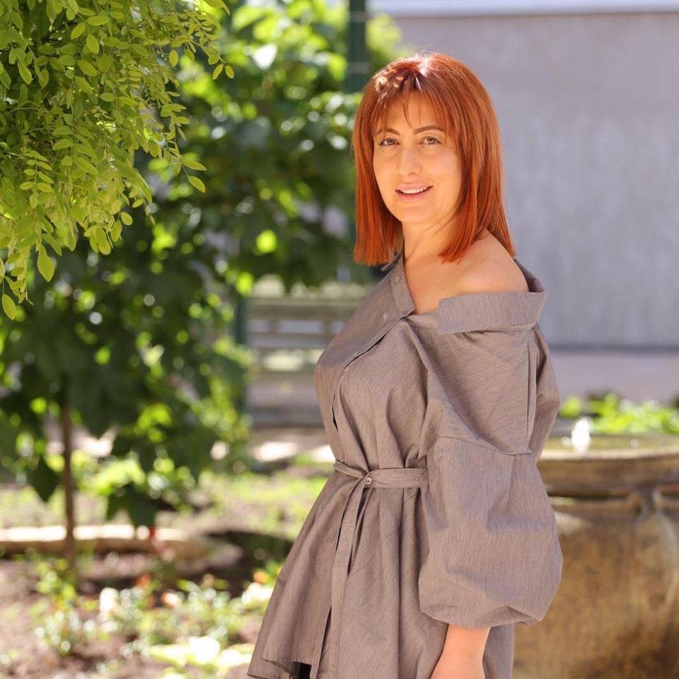 Amalya Yeghoyan standing outdoors by a tree