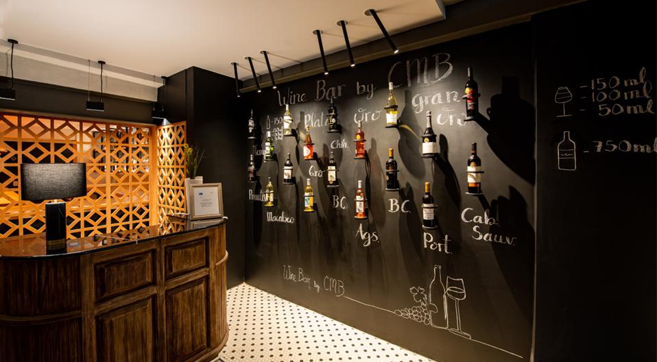 A full wall blackboard serves as the main wine list at Wine Bar by CMB in Mexico City.