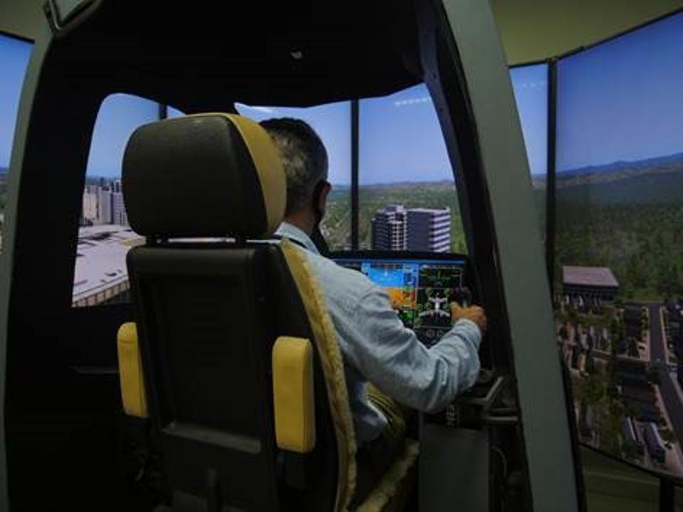 Man flying EVTOL aircraft. (Simulator image.)