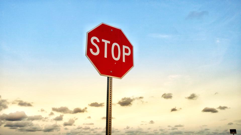 Low Angle View Of Stop Sign Against Sky