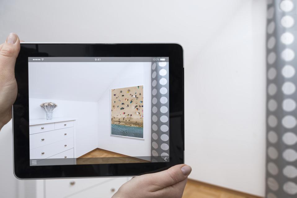 Digital tablet displaying framed image in a room