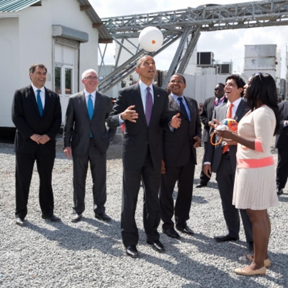 Barack Obama tosses a Soccket ball in the air at the Ubongo Power Plant in Dar es Salaam, Tanzania