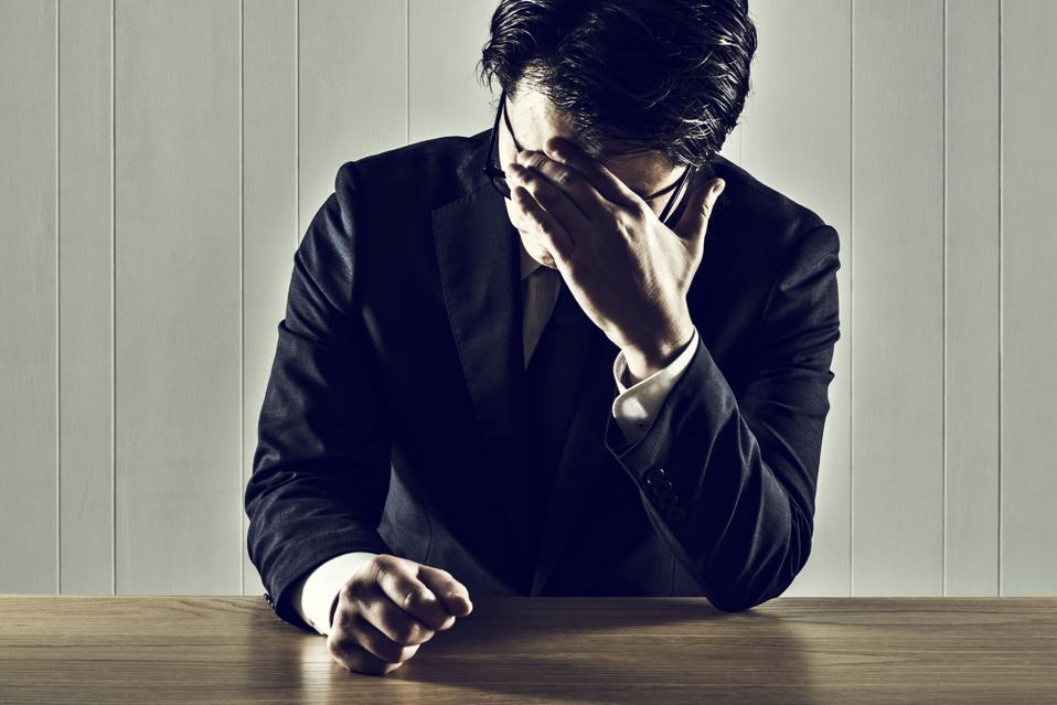 Businessman holding a head