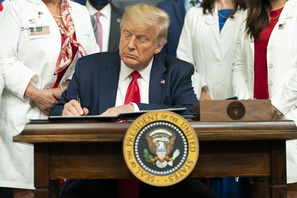President Donald Trump signs a series of Executive Orders on lowering drug prices Friday, July 24, 2020