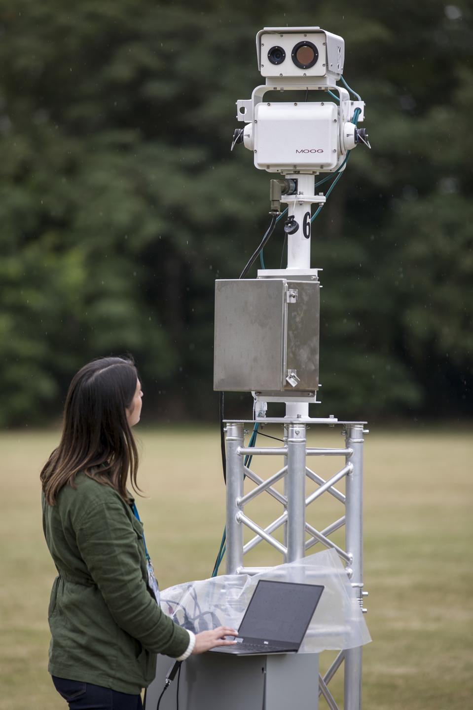 An engineer operates a Gas Cloud Imaging (GCI) camera.