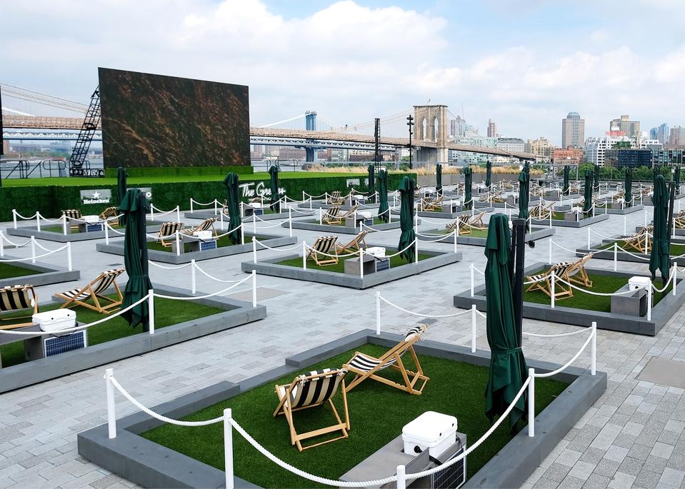 mini lawns with lounge chairs on the rooftop of New York's Pier 17 overlooking the East River.