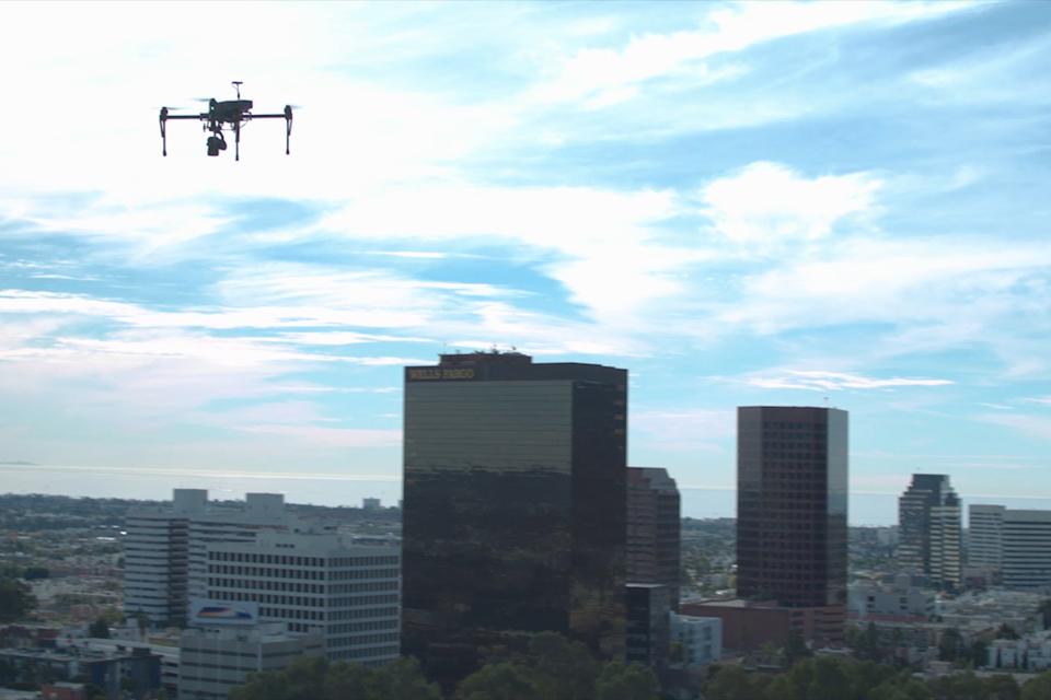 A PrecisionHawk drone over an urban landscape.