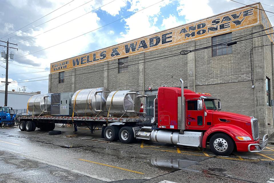 A truck coordinated by Brew Movers shipping logistics carries beer equipment