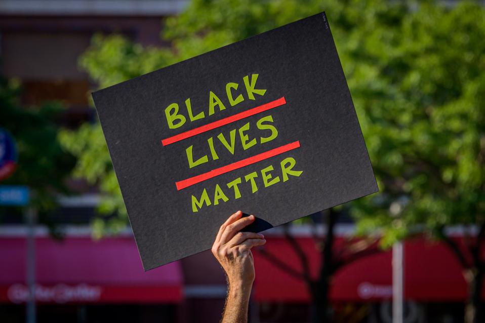 A participant holding a Black Lives Matter sign at the...