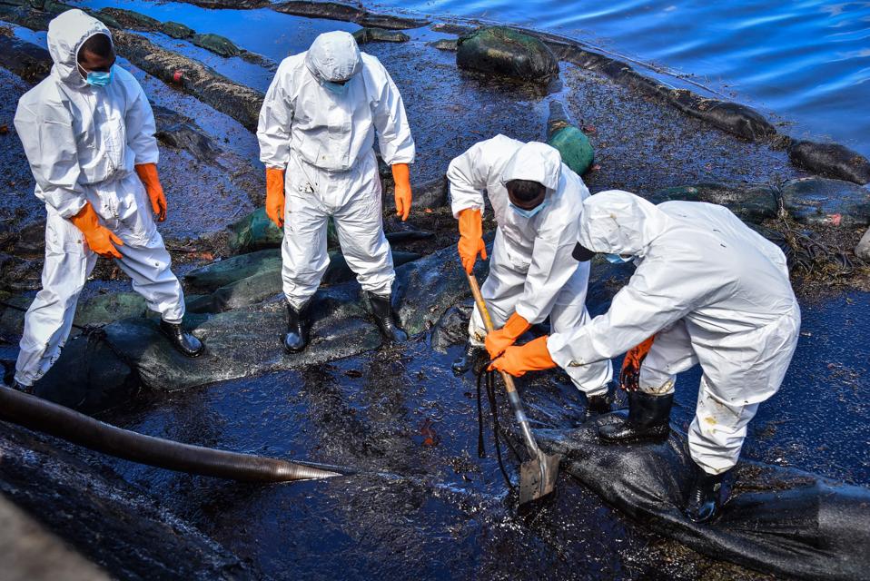 Volunteers collect leaked oil from the MV Wakashio from beach in Bois des Amourettes, Mauritius, on August 13, 2020.