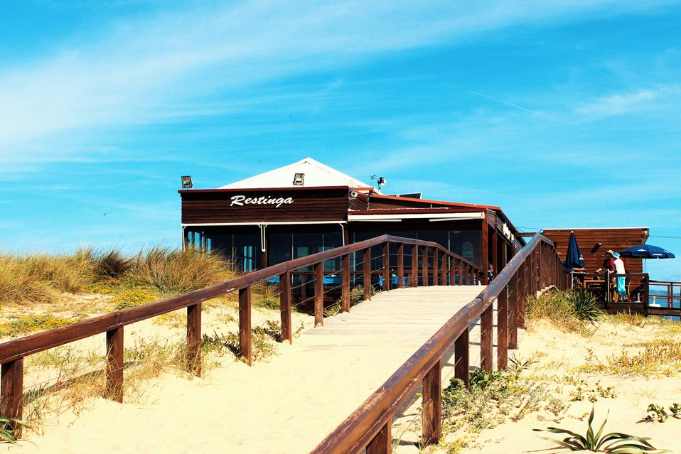 A boardwalk leads to Restinga restaurant in the Algarve, Portugal.