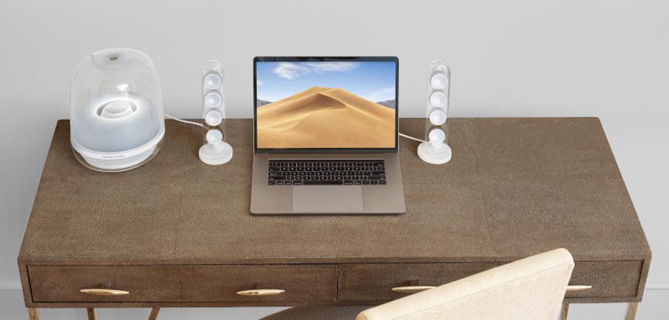 Harman SoundSticks 4 on a desk with a laptop