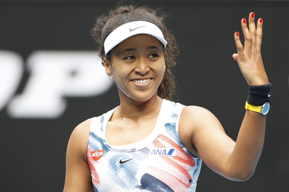 MELBOURNE, AUSTRALIA - JANUARY 22: Naomi Osaka of Japan shows appreciation to the crowd after winning her Women's Singles second round match against Saisai Zheng of China on day three of the 2020 Australian Open at Melbourne Park on January 22, 2020 in Melbourne, Australia.  (Photo by Fred Lee/Getty Images)