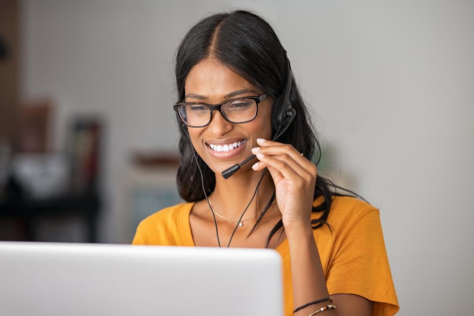 Woman working remotely, talking on headset