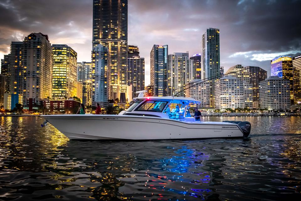 Fishing vessel against night time Miami skyline