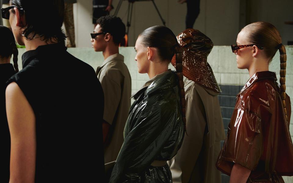 Models wait dressed up for the filming of Rains' Never Lost SS21 collection fashion film.