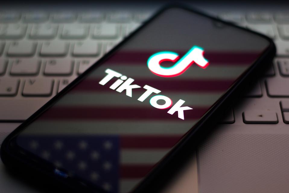 The Tik Tok logo with an American flag background.