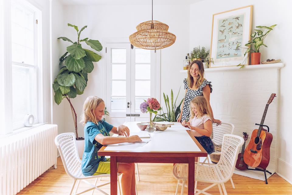 Children at a dining table with a rattan light fixture.