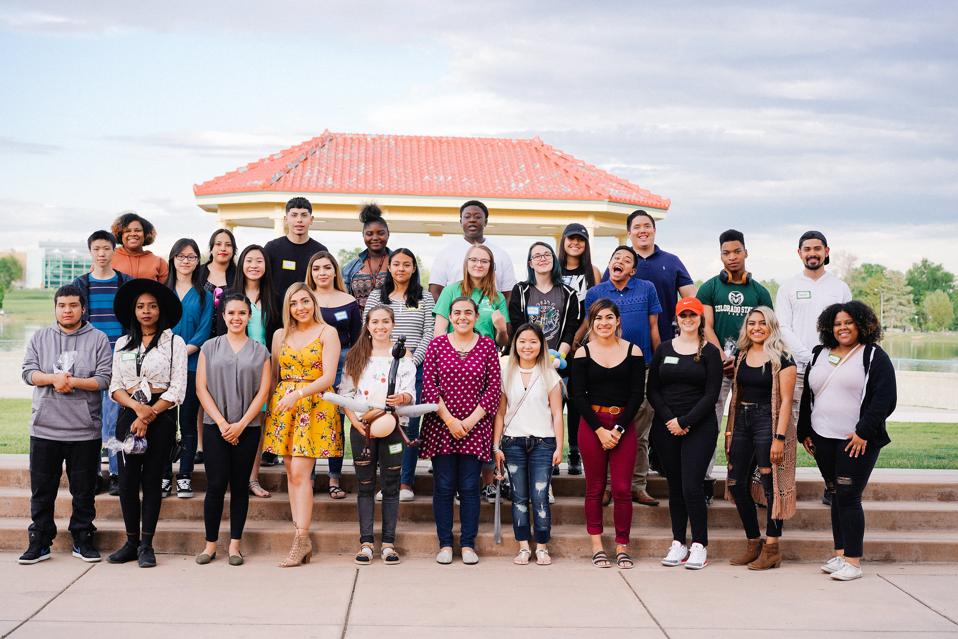 diverse group of 27 Denver Scholars posing for a picture in front of a gazebo in the daytime