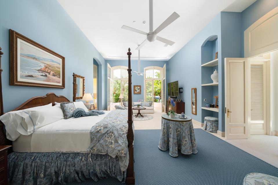 Master bedroom with ceiling fan and French doors