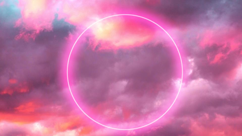 Futuristic neon circle in the burning sky with stunning pink colors.