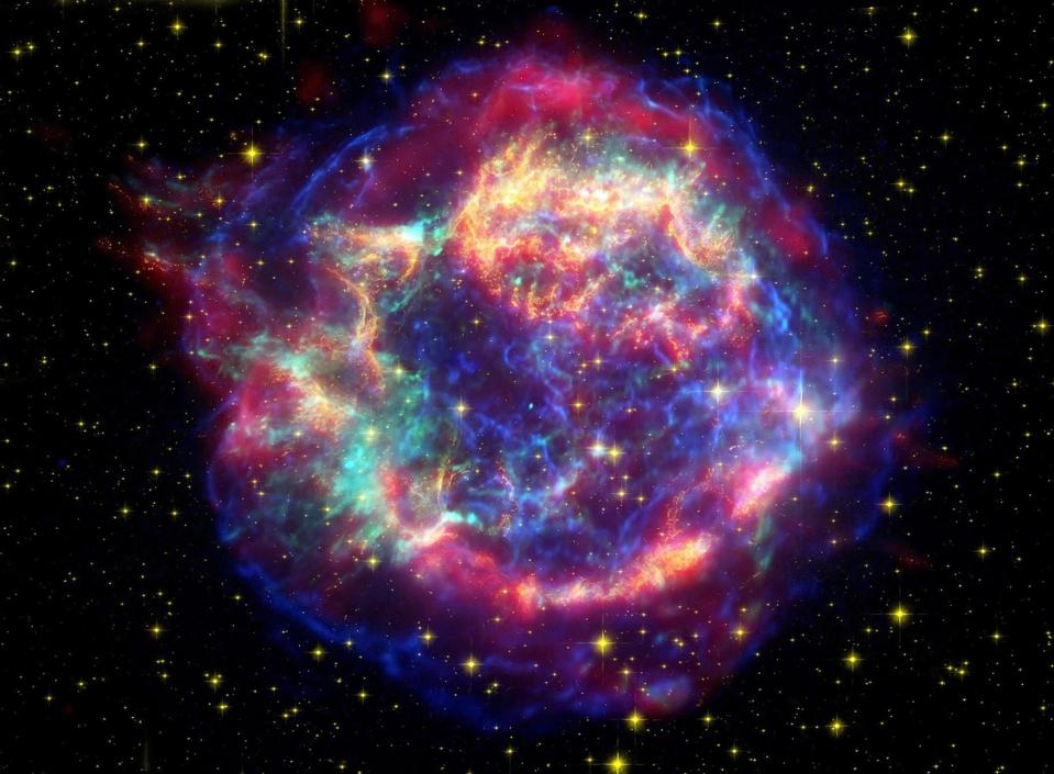 This false-color picture shows off the many sides of the supernova remnant Cassiopeia A, which is made up of images taken by three observatories, using three different wavebands of light.